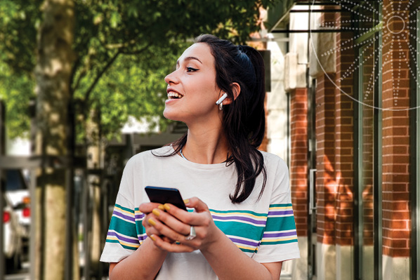 young woman walking while listening to music